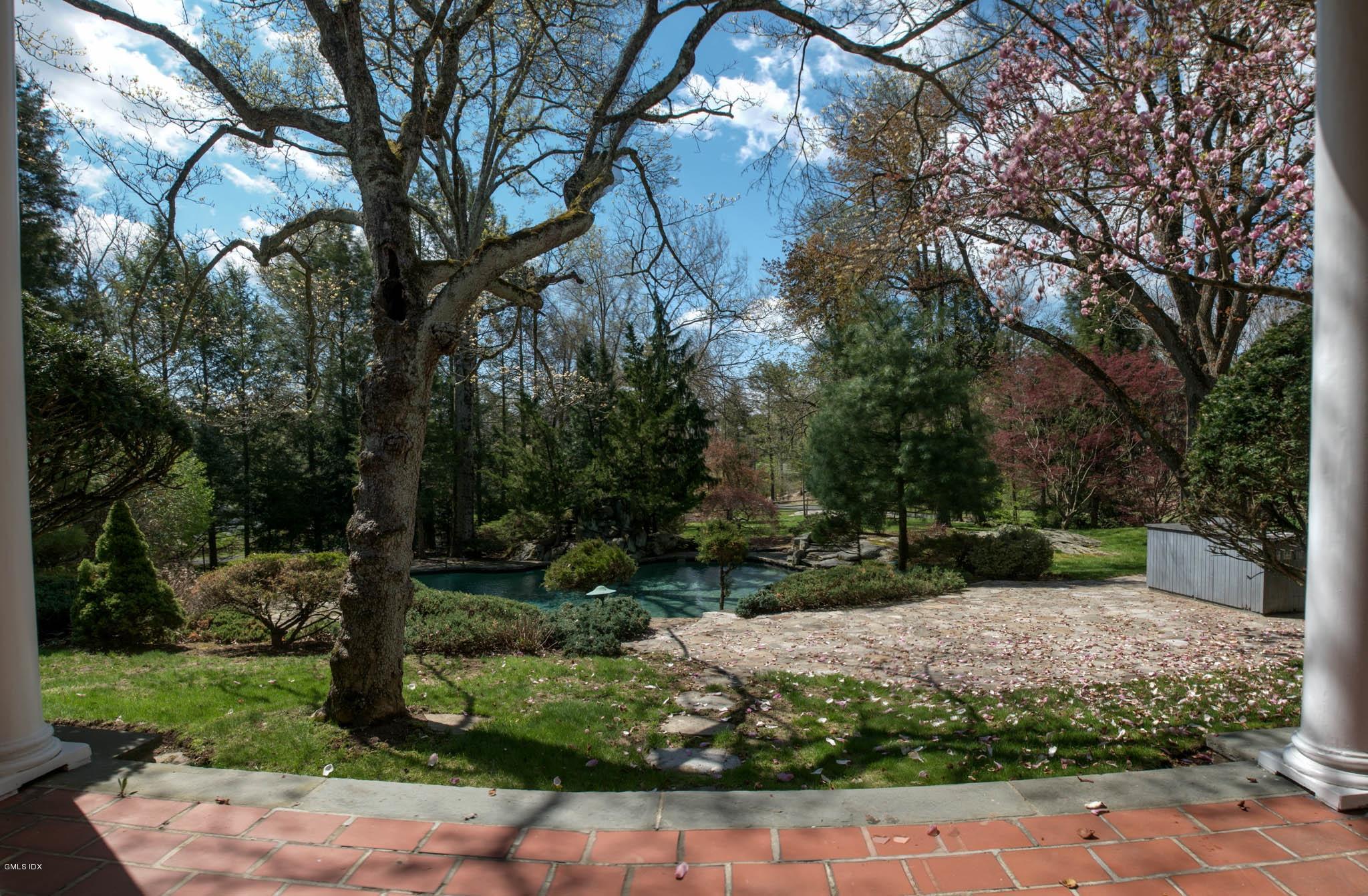 105 Dingletown Road Greenwich, CT 06830 - Photo 35 of 65 a view of a backyard with large trees