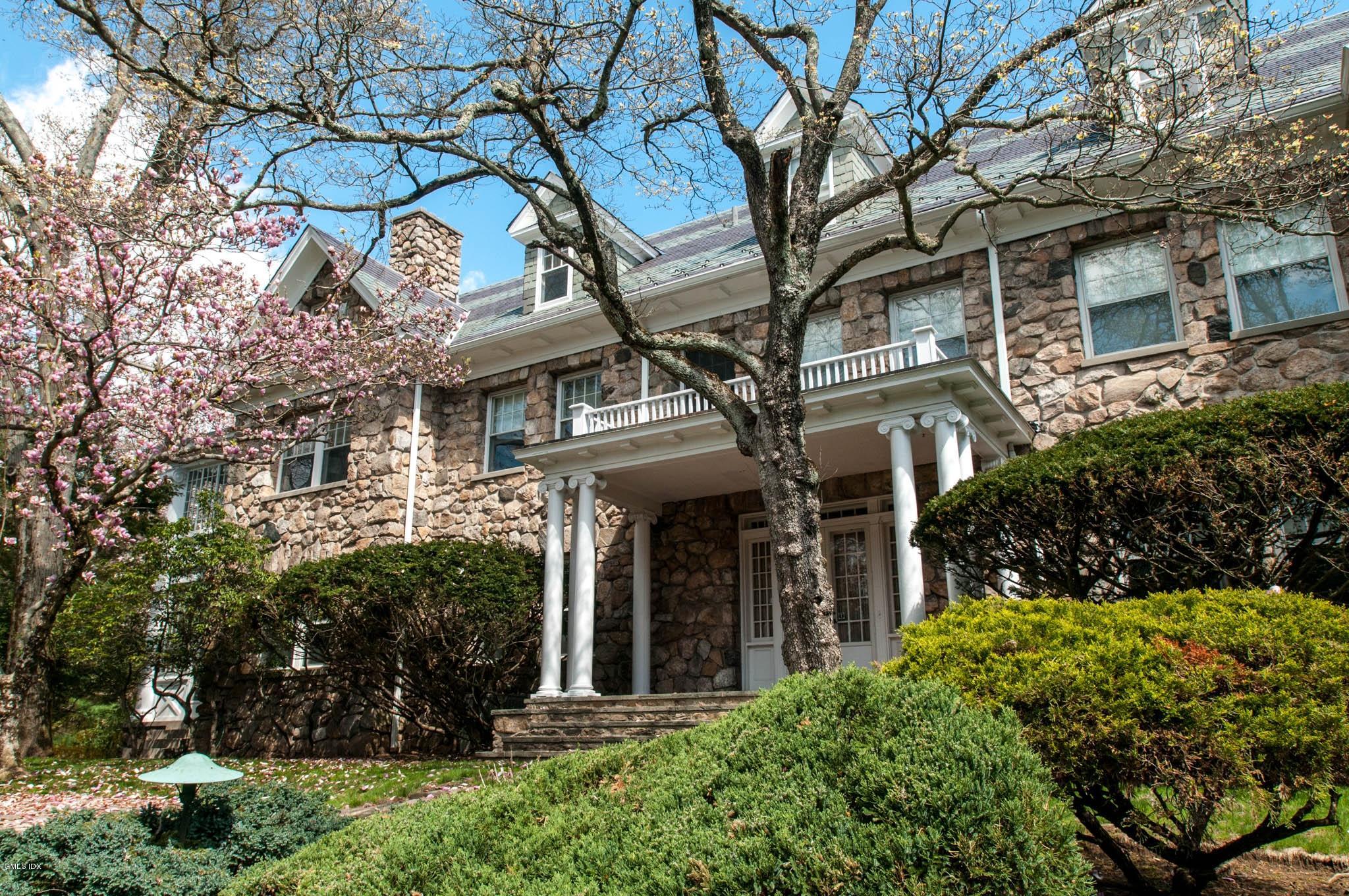 105 Dingletown Road Greenwich, CT 06830 - Photo 37 of 65 a view of a brick house with a large tree and windows