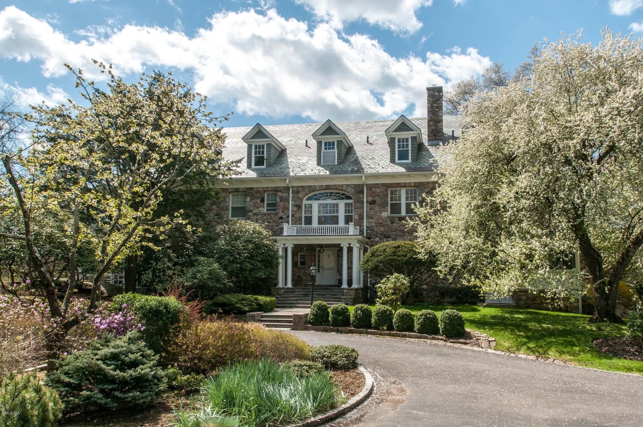 105 Dingletown Road Greenwich, CT 06830 - Photo 40 of 65 a front view of a house with a yard and potted plants