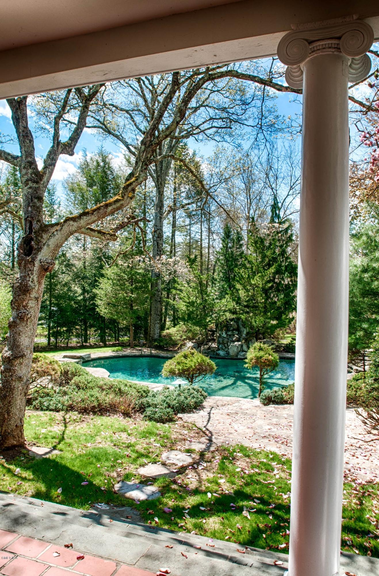 105 Dingletown Road Greenwich, CT 06830 - Photo 4 of 65 a view of a yard in front of a house with a large tree