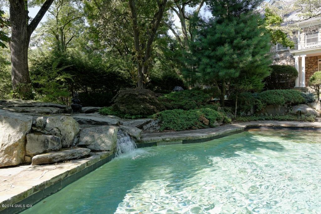 105 Dingletown Road Greenwich, CT 06830 - Photo 56 of 65 a view of a garden with a fountain
