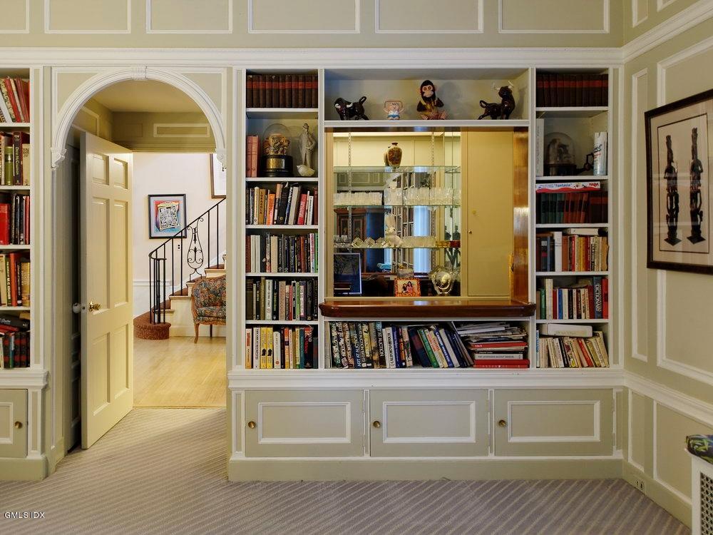 105 Dingletown Road Greenwich, CT 06830 - Photo 10 of 65 a living room with fish tank and a bookshelf