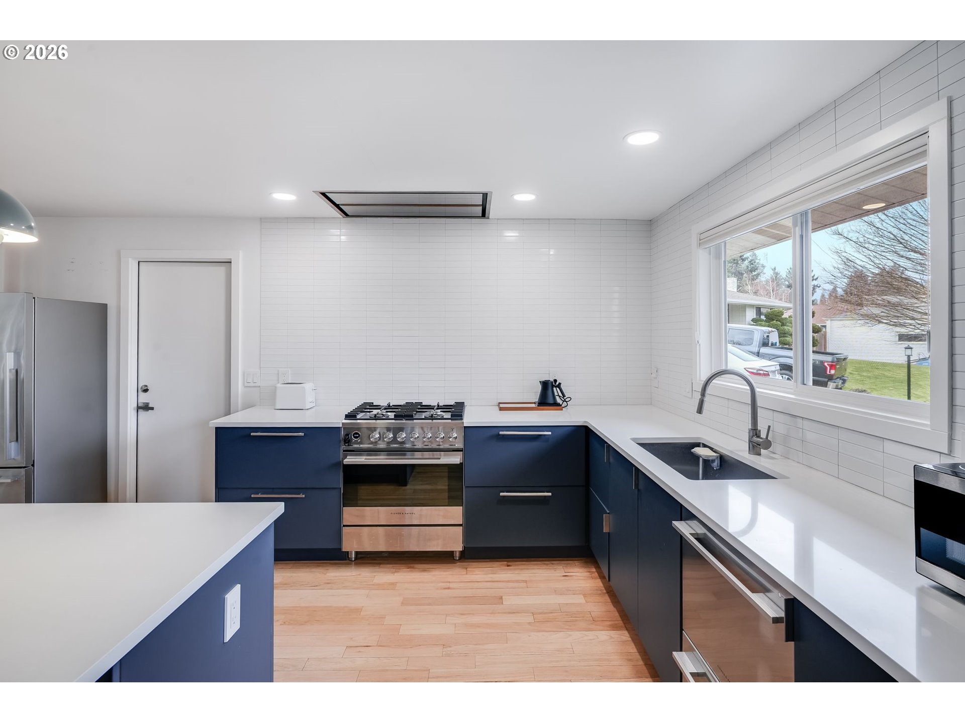 5214 Northeast Jessup Street Portland, OR 97218 - Photo 11 of 28 a kitchen with stainless steel appliances granite countertop a sink stove and refrigerator