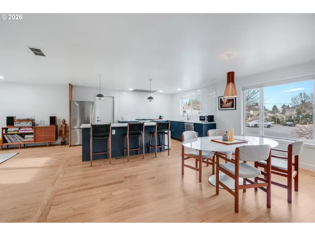 a living room with lots of furniture and a large window