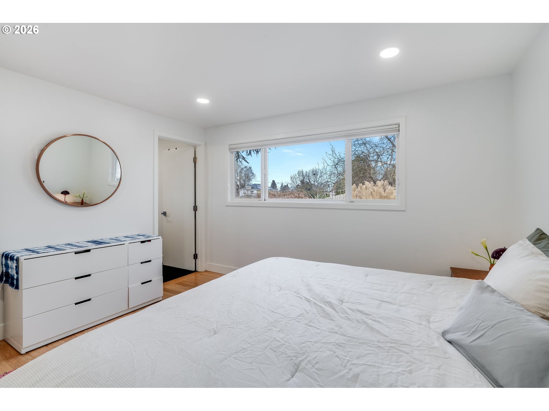 5214 Northeast Jessup Street Portland, OR 97218 - Photo 19 of 28 a bedroom with a bed and a chandelier