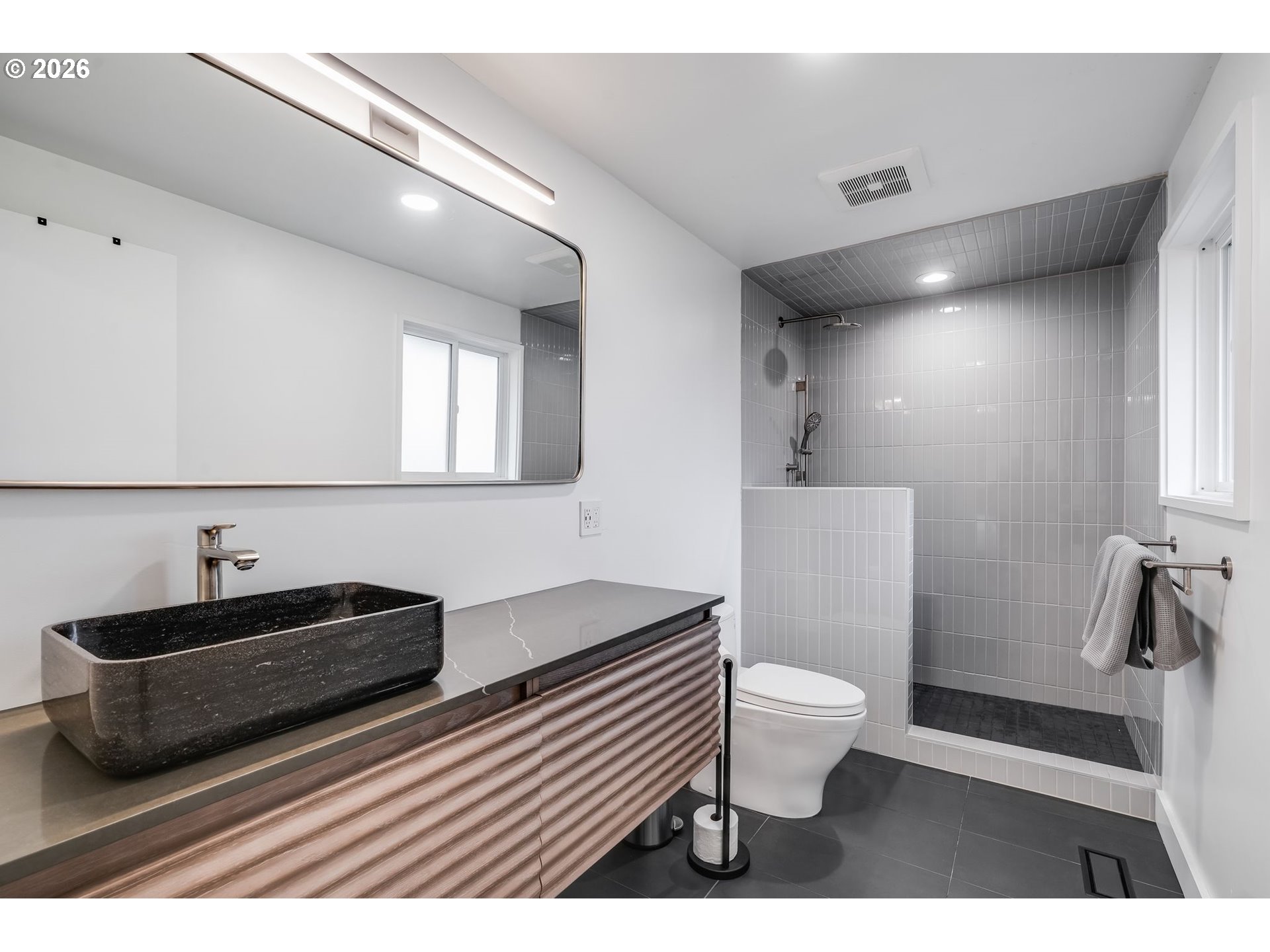 5214 Northeast Jessup Street Portland, OR 97218 - Photo 20 of 28 a bathroom with a sink a toilet a mirror and shower
