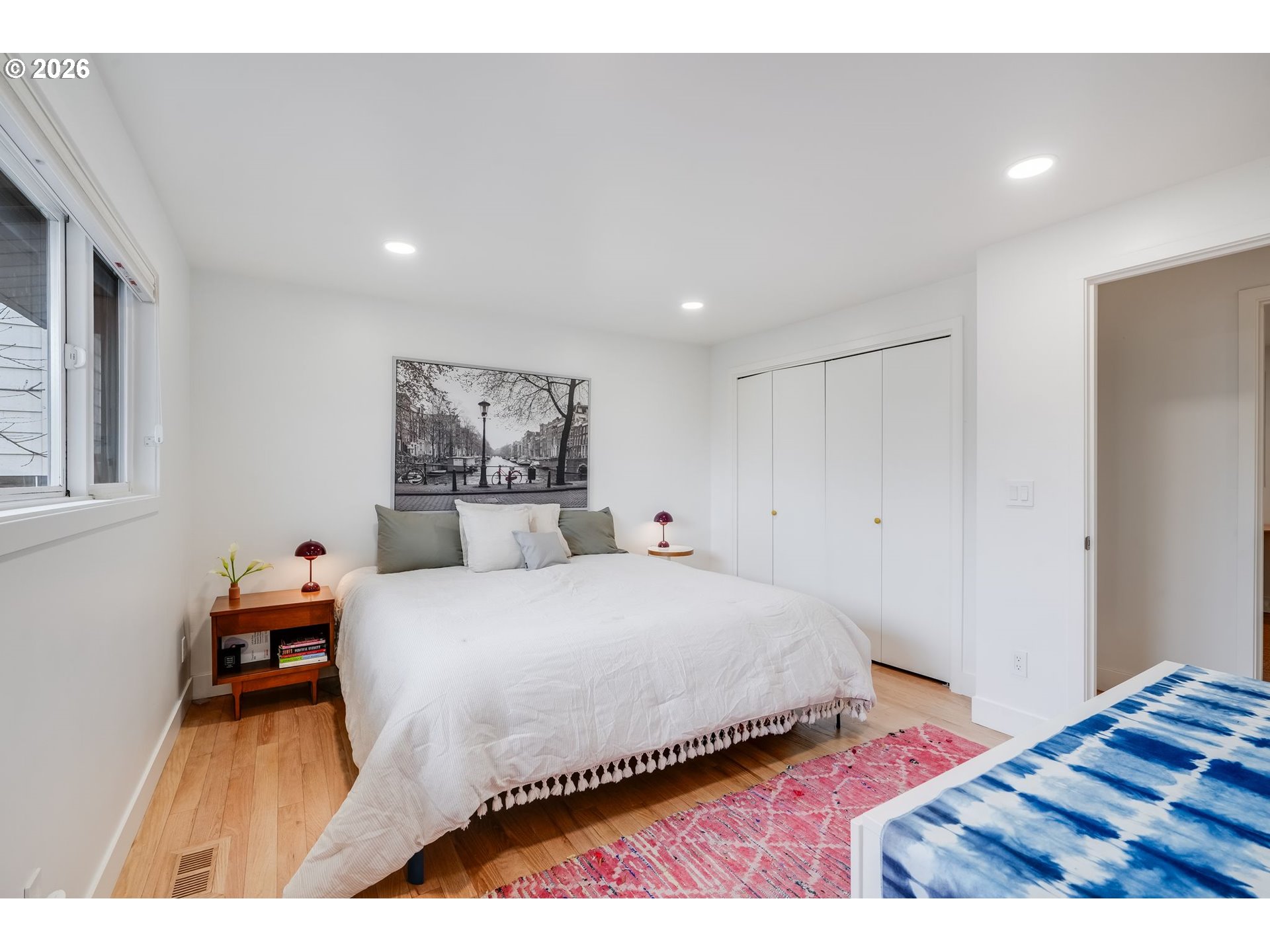 5214 Northeast Jessup Street Portland, OR 97218 - Photo 21 of 28 a bedroom with a bed and a painting on the wall