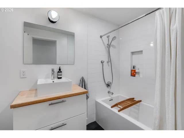 a bathroom with a sink a mirror and shower