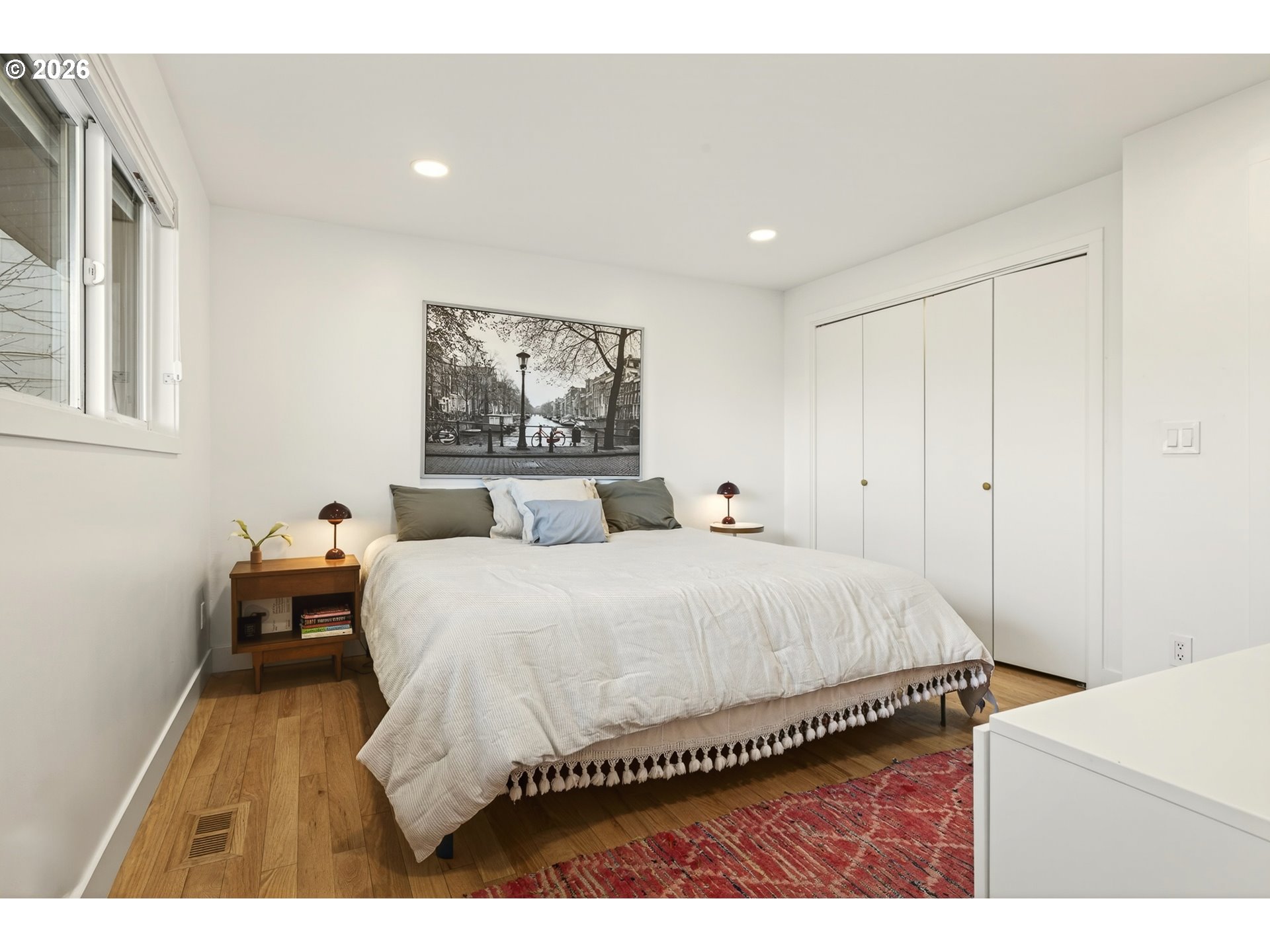 5214 Northeast Jessup Street Portland, OR 97218 - Photo 30 of 36 a spacious bedroom with a bed and a cabinets