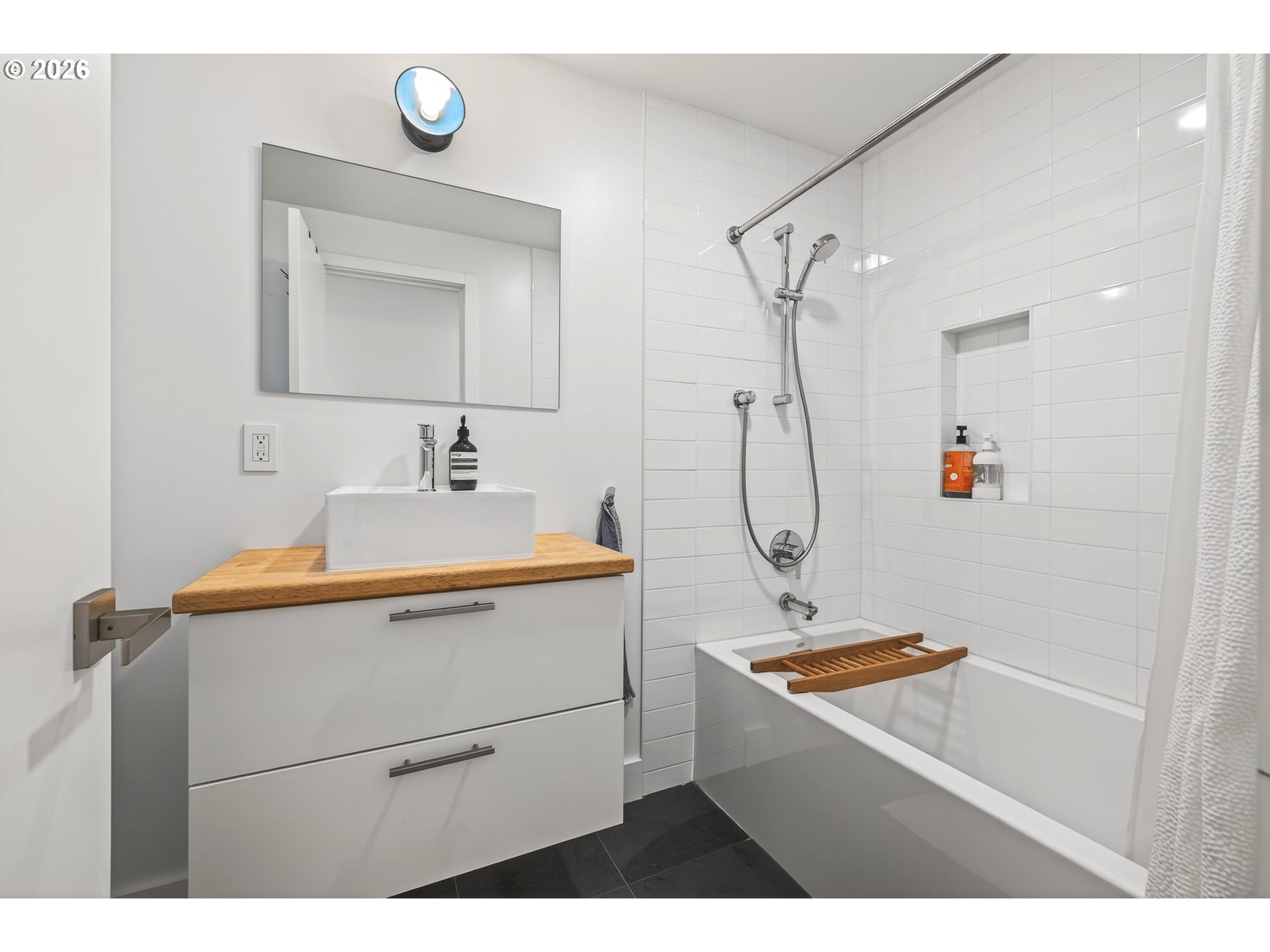 5214 Northeast Jessup Street Portland, OR 97218 - Photo 32 of 36 a bathroom with a sink vanity granite and a mirror