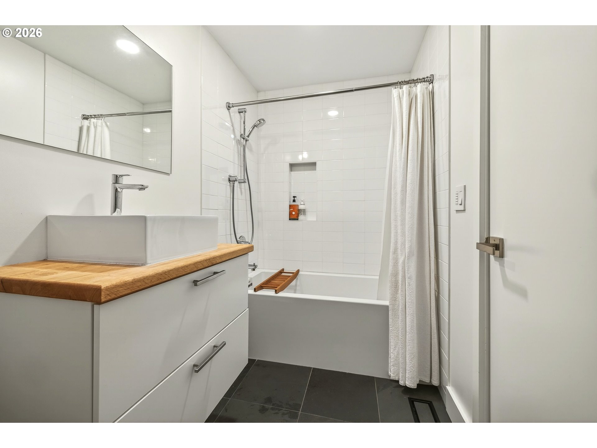 5214 Northeast Jessup Street Portland, OR 97218 - Photo 33 of 36 a bathroom with a tub a sink and a shower