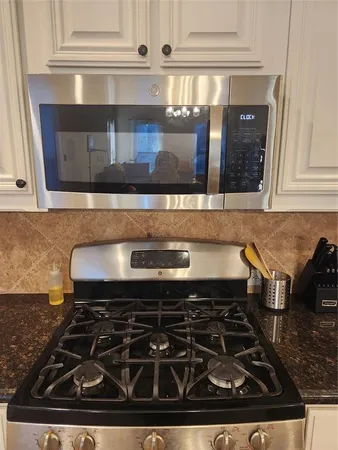 a kitchen with a stove and cabinets