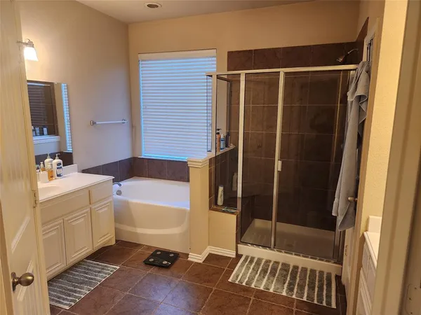 a bathroom with a shower and a sink