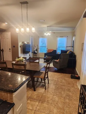 a living room with lots of furniture and kitchen view