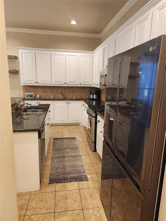a kitchen with a sink a stove and cabinets