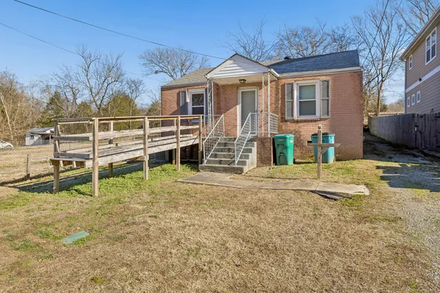 a view of a house with wooden fence