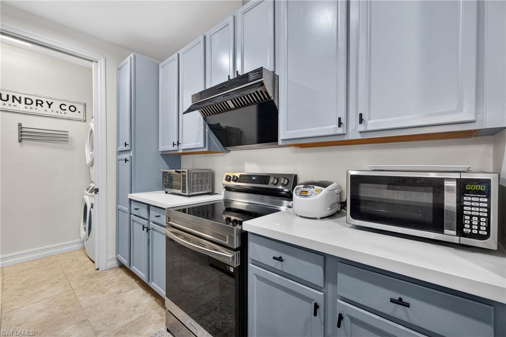 7845 Bristol Circle Naples, FL 34120 - Photo 12 of 31 a kitchen with cabinets stainless steel appliances and a sink