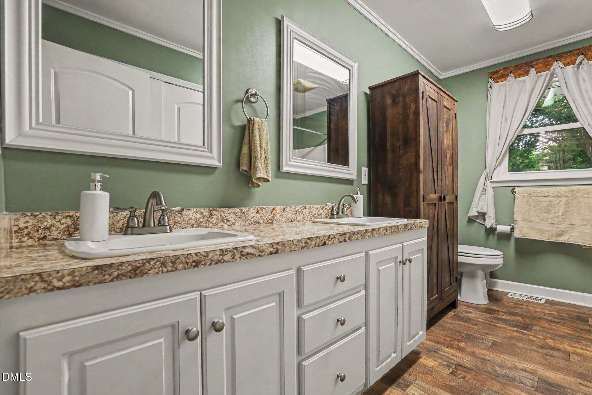 977 Stevens Mill Road Goldsboro, NC 27530 - Photo 22 of 31 a bathroom with a granite countertop sink and a mirror