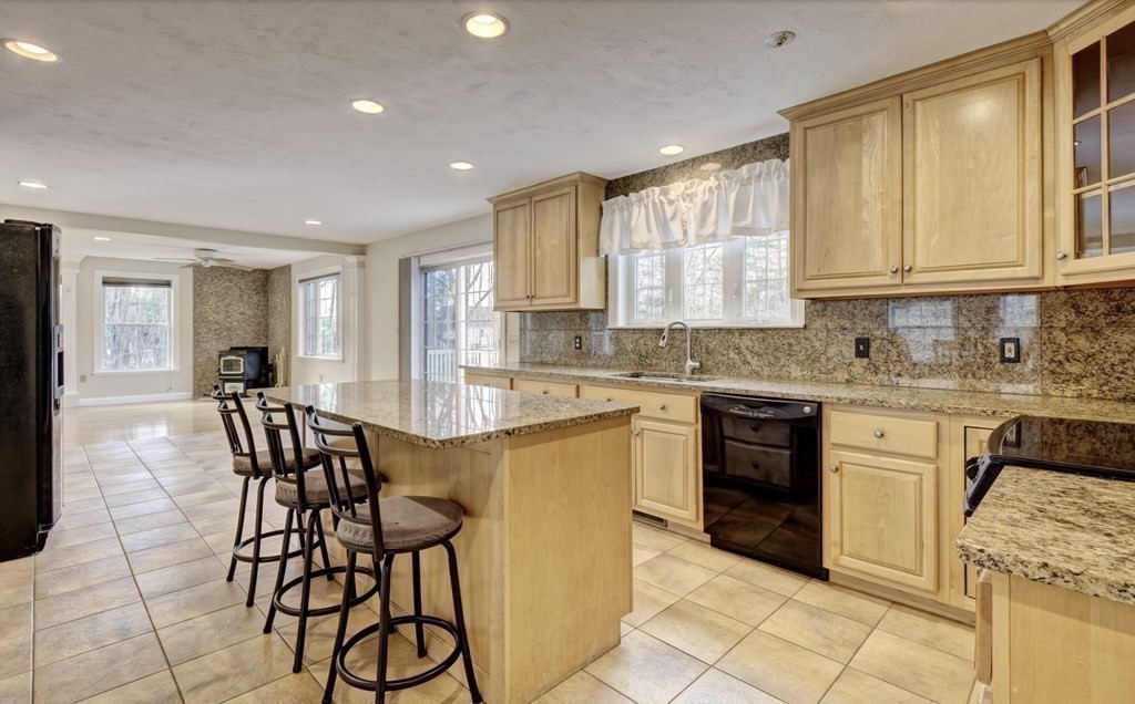 6 Elizabeth Road Auburn, MA 01501 - Photo 12 of 41 a kitchen with stainless steel appliances granite countertop wooden floor a stove a sink a microwave and a refrigerator
