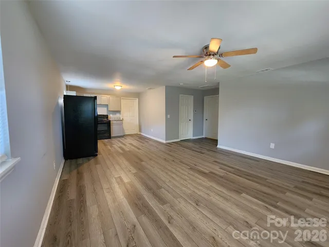 a view of a livingroom with a ceiling fan and window