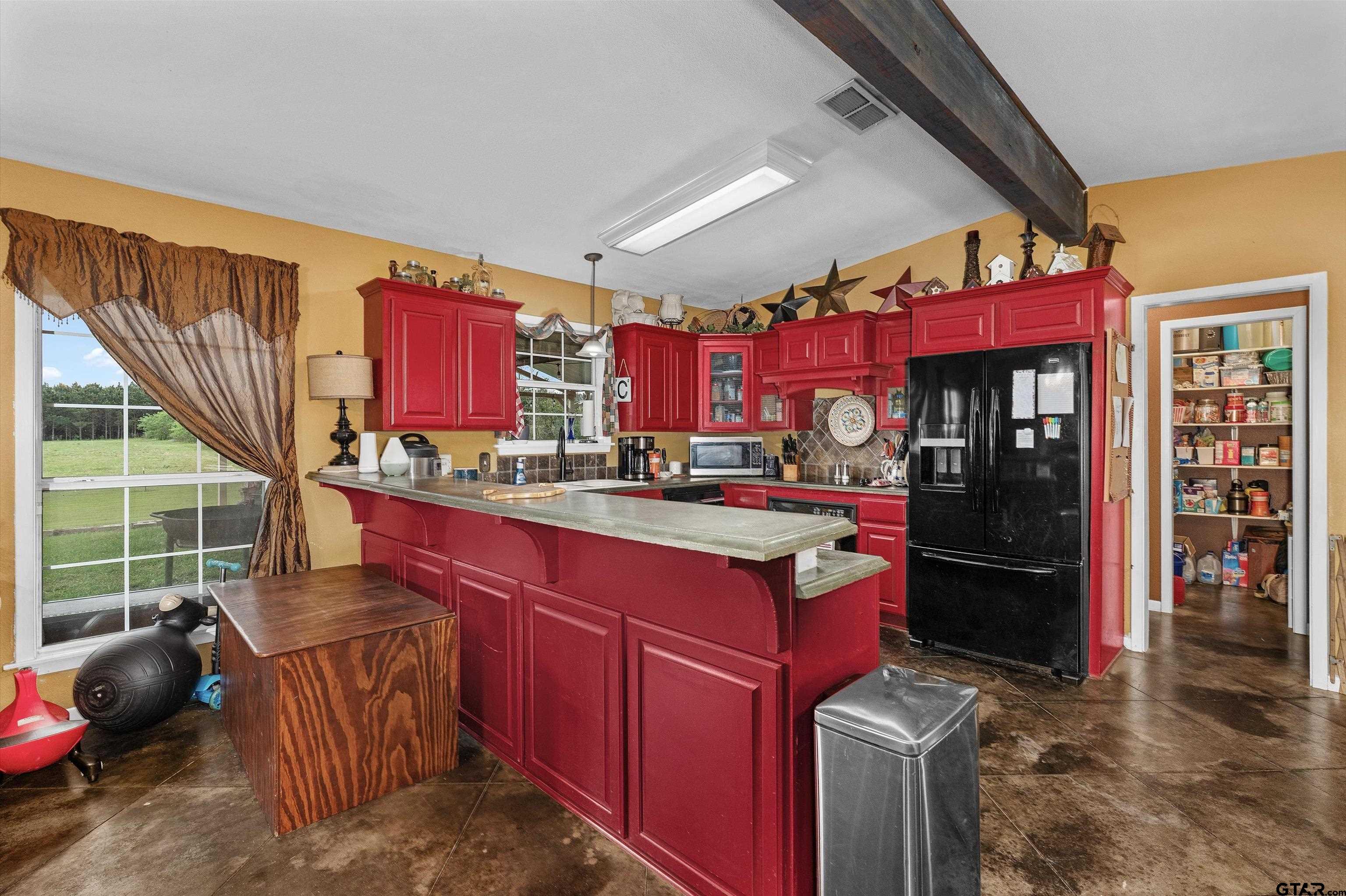 8550 New Hope Road Gilmer, TX 75645 - Photo 7 of 12 a kitchen with stainless steel appliances kitchen island granite countertop a refrigerator and a stove