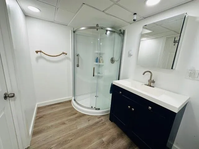 a spacious bathroom with a double vanity sink toilet mirror and shower