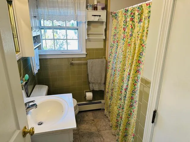 a bathroom with a sink and a shower curtain