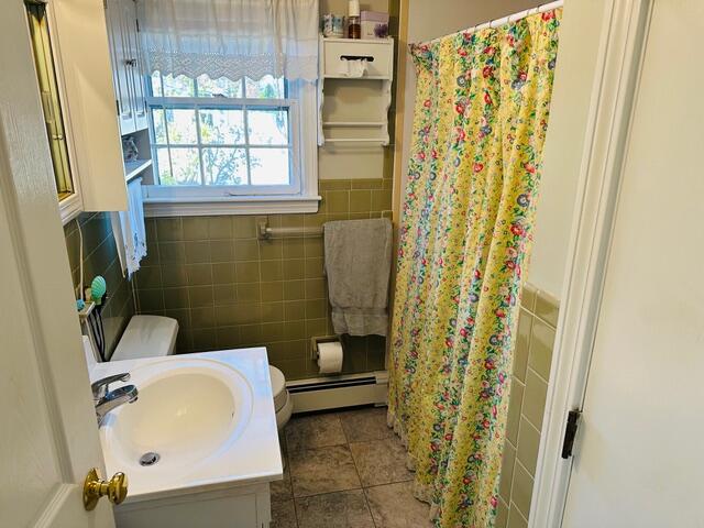 8 Jasmine Lane Hyannis, MA 02601 - Photo 10 of 28 a bathroom with a sink and a shower curtain