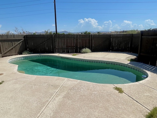 5075 Mountain View Road Fort Mohave, AZ 86426 - Photo 24 of 27 View of pool featuring a gate and a double patio area