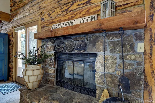 a dining room with stainless steel appliances granite countertop a table chairs and a chandelier