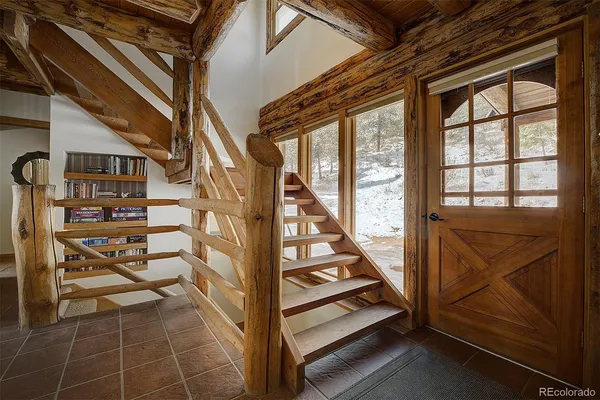 a living room with furniture fireplace and a large window