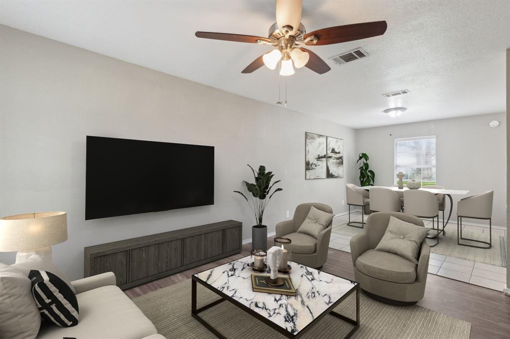 806 East College Street Terrell, TX 75160 - Photo 3 of 29 a living room with furniture a flat screen tv and a lamp