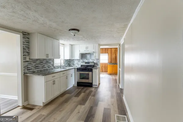a kitchen with granite countertop stainless steel appliances and counter space