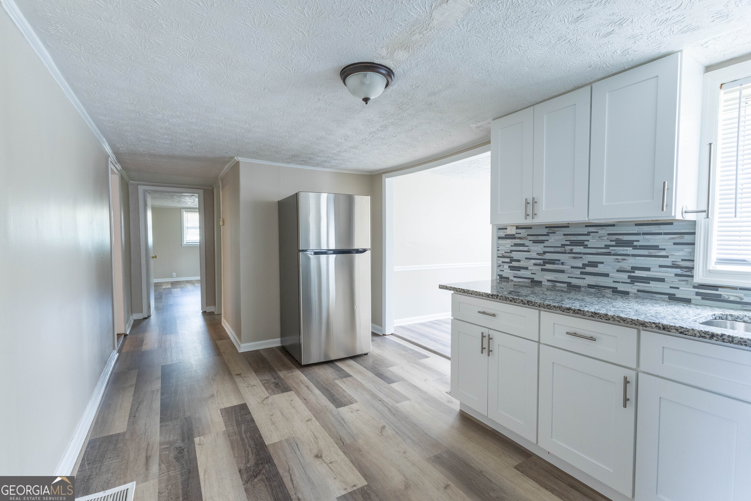 5326 Heardsville Road Cumming, GA 30028 - Photo 14 of 22 a kitchen with granite countertop a refrigerator and a sink