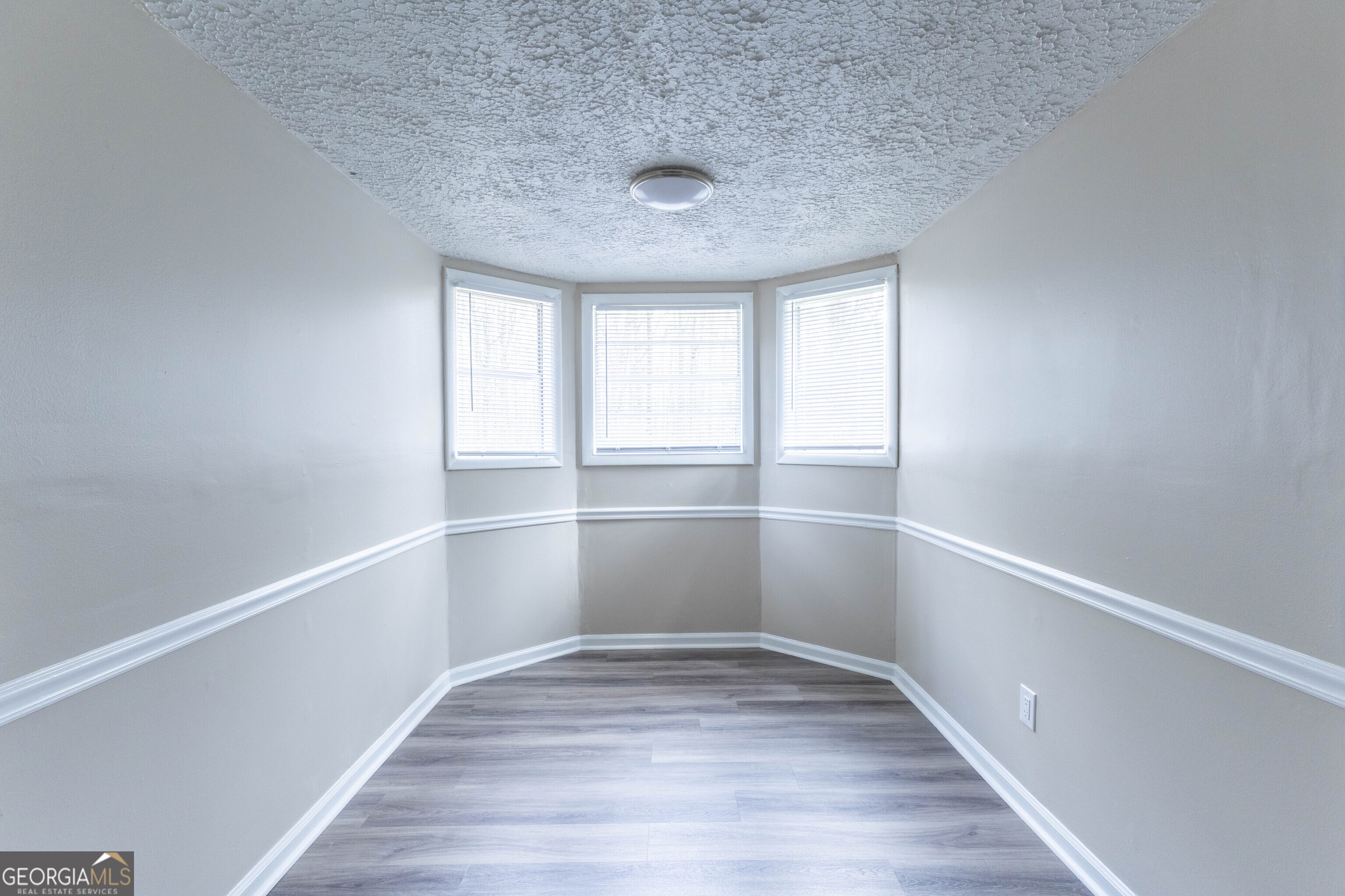 5326 Heardsville Road Cumming, GA 30028 - Photo 15 of 22 a view of an empty room with wooden floor and window