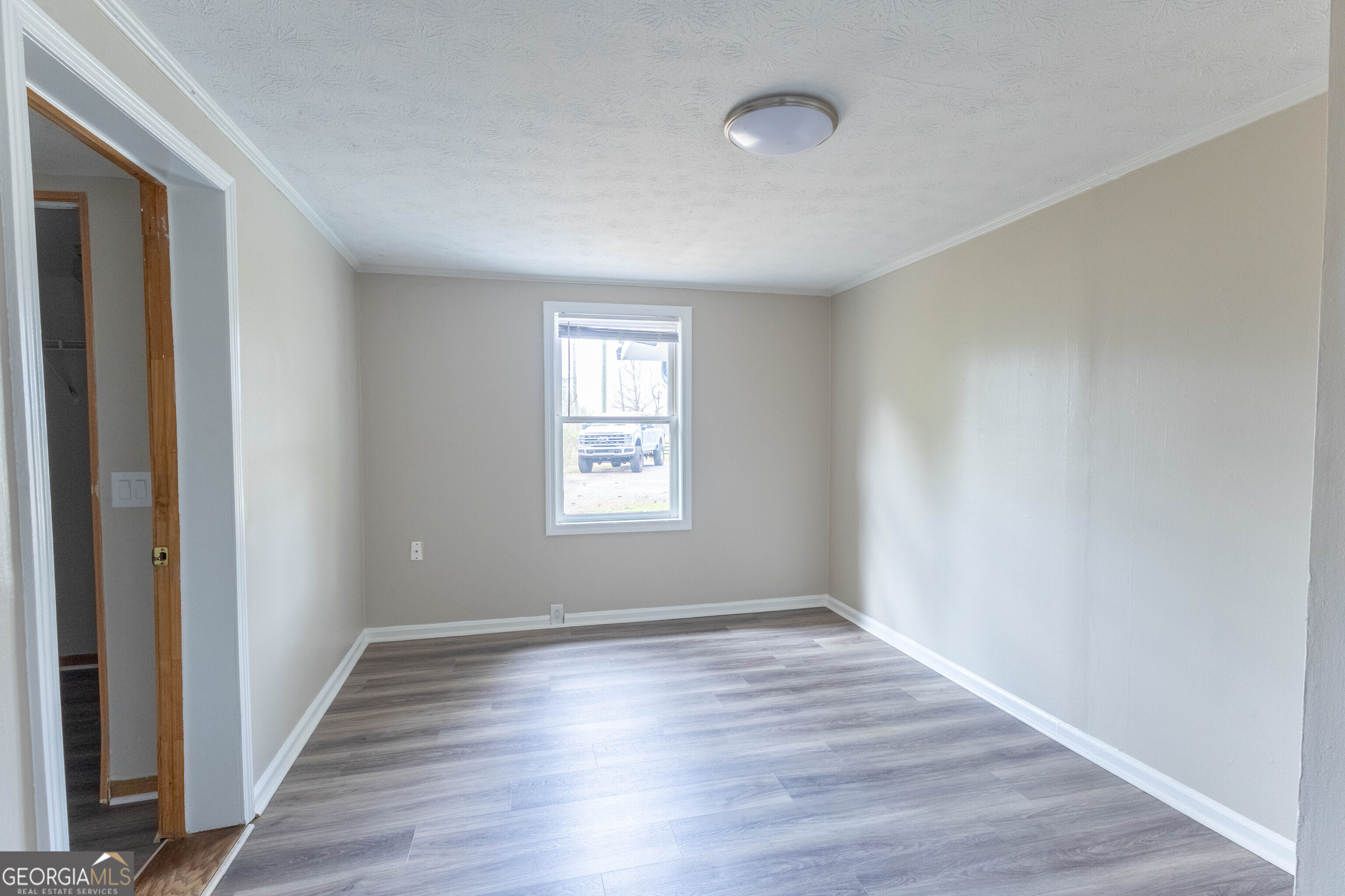 5326 Heardsville Road Cumming, GA 30028 - Photo 16 of 22 wooden floor in an empty room with a window