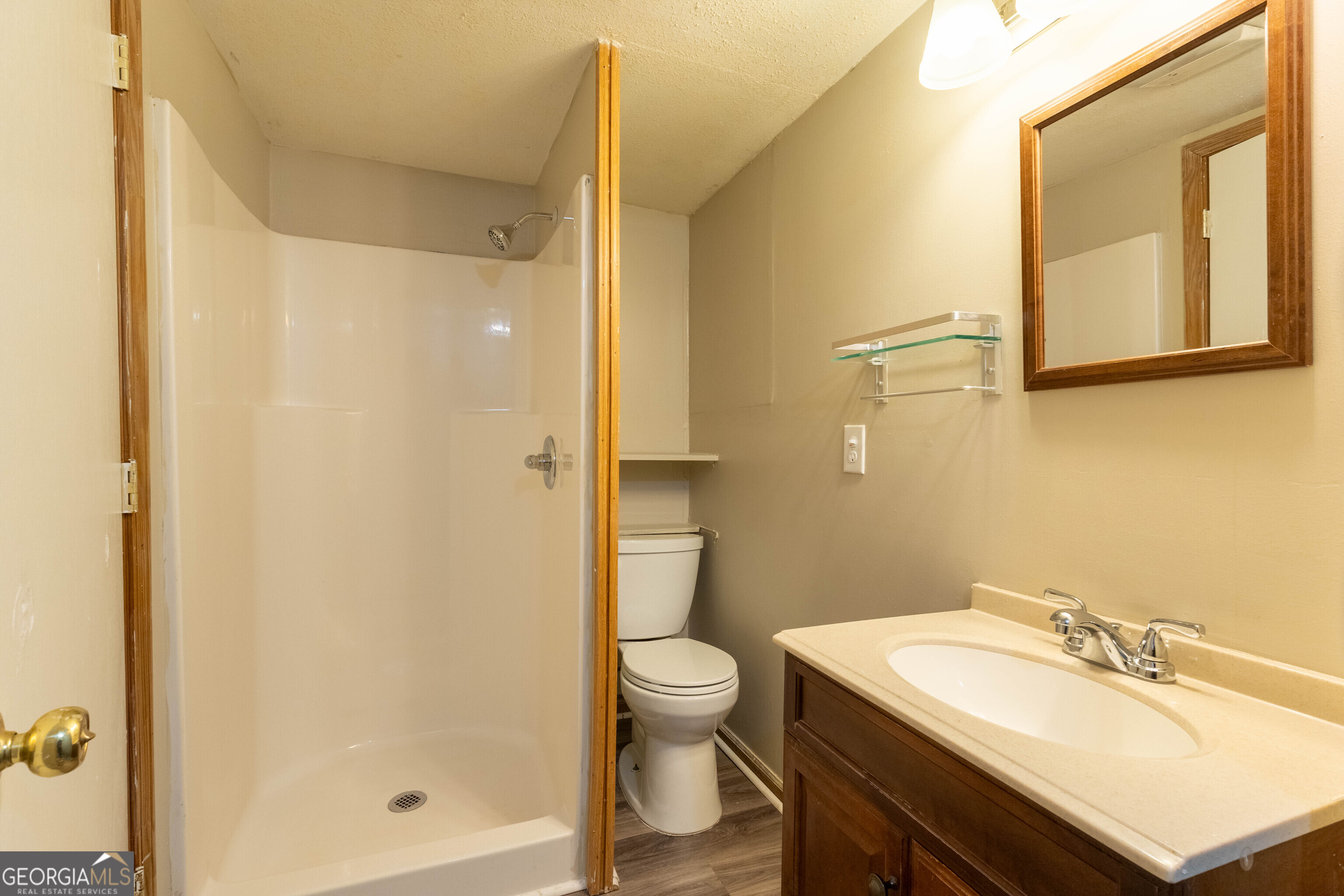 5326 Heardsville Road Cumming, GA 30028 - Photo 18 of 22 a bathroom with a sink a toilet and shower