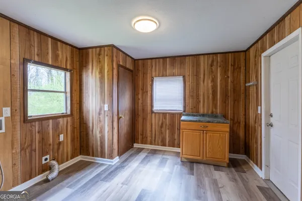 an empty room with wooden floor and a window