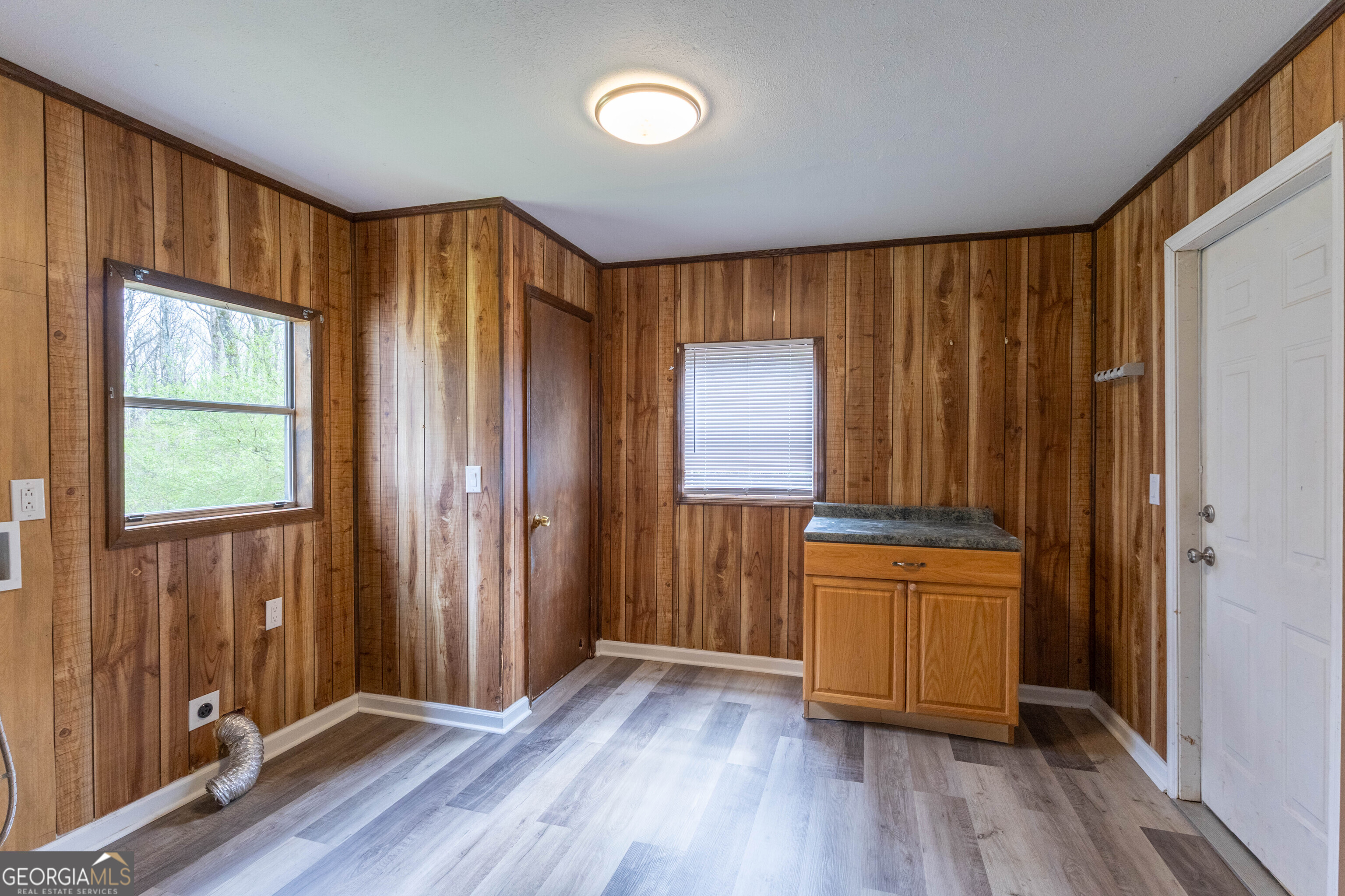 5326 Heardsville Road Cumming, GA 30028 - Photo 19 of 22 an empty room with wooden floor and a window