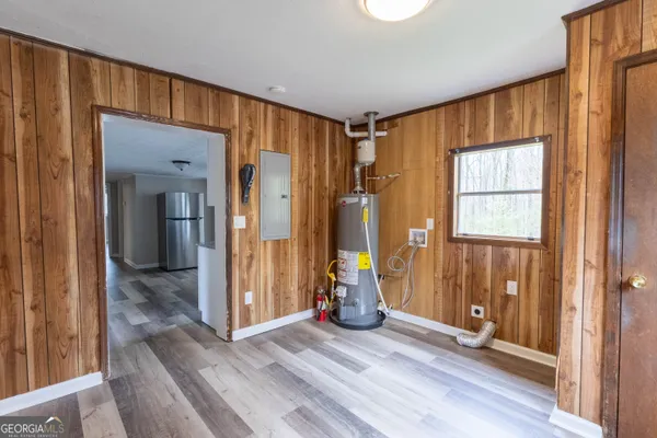 a view of a room with wooden floor and windows