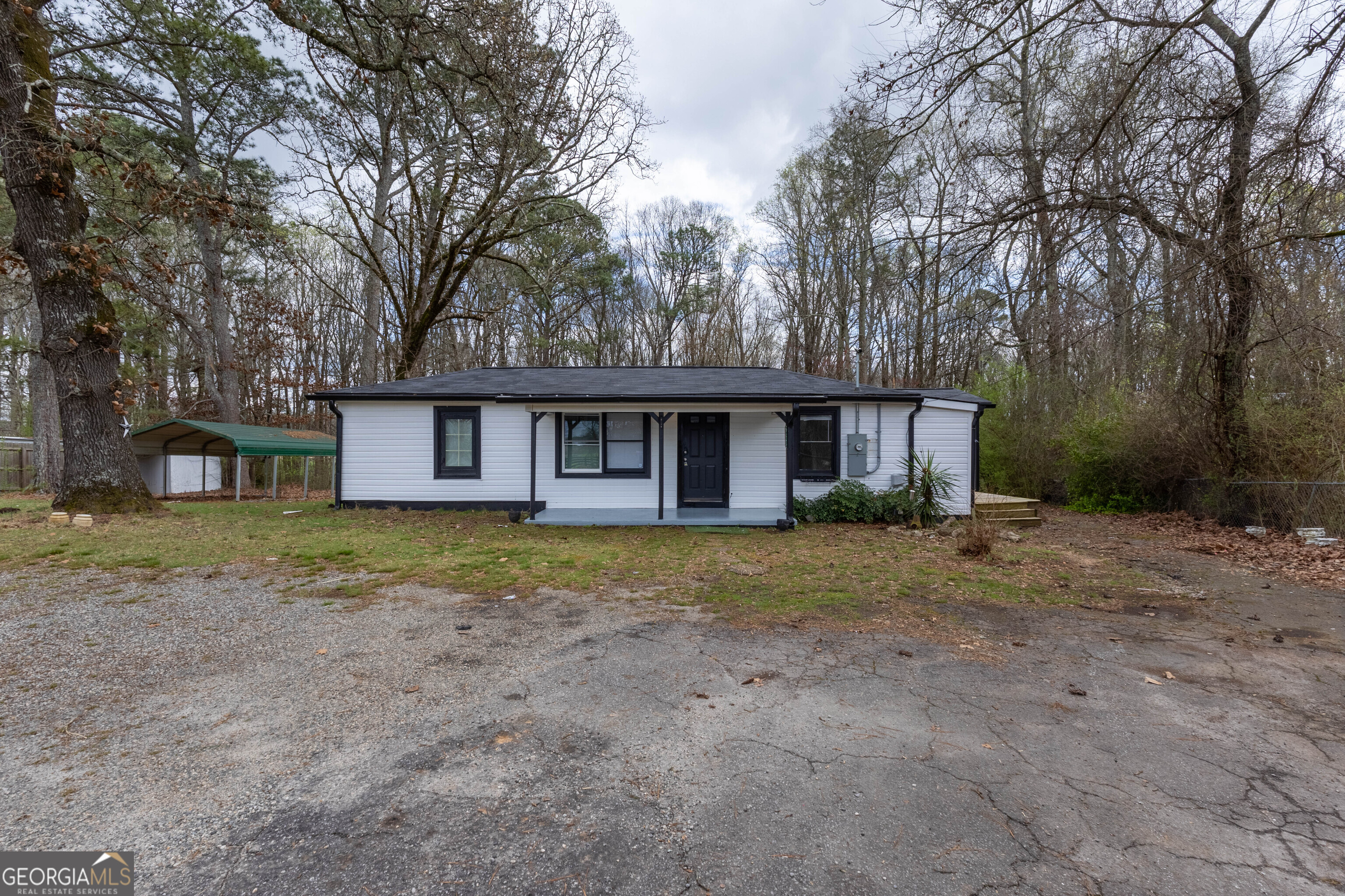 5326 Heardsville Road Cumming, GA 30028 - Photo 2 of 22 a view of a yard in front of a house with large trees