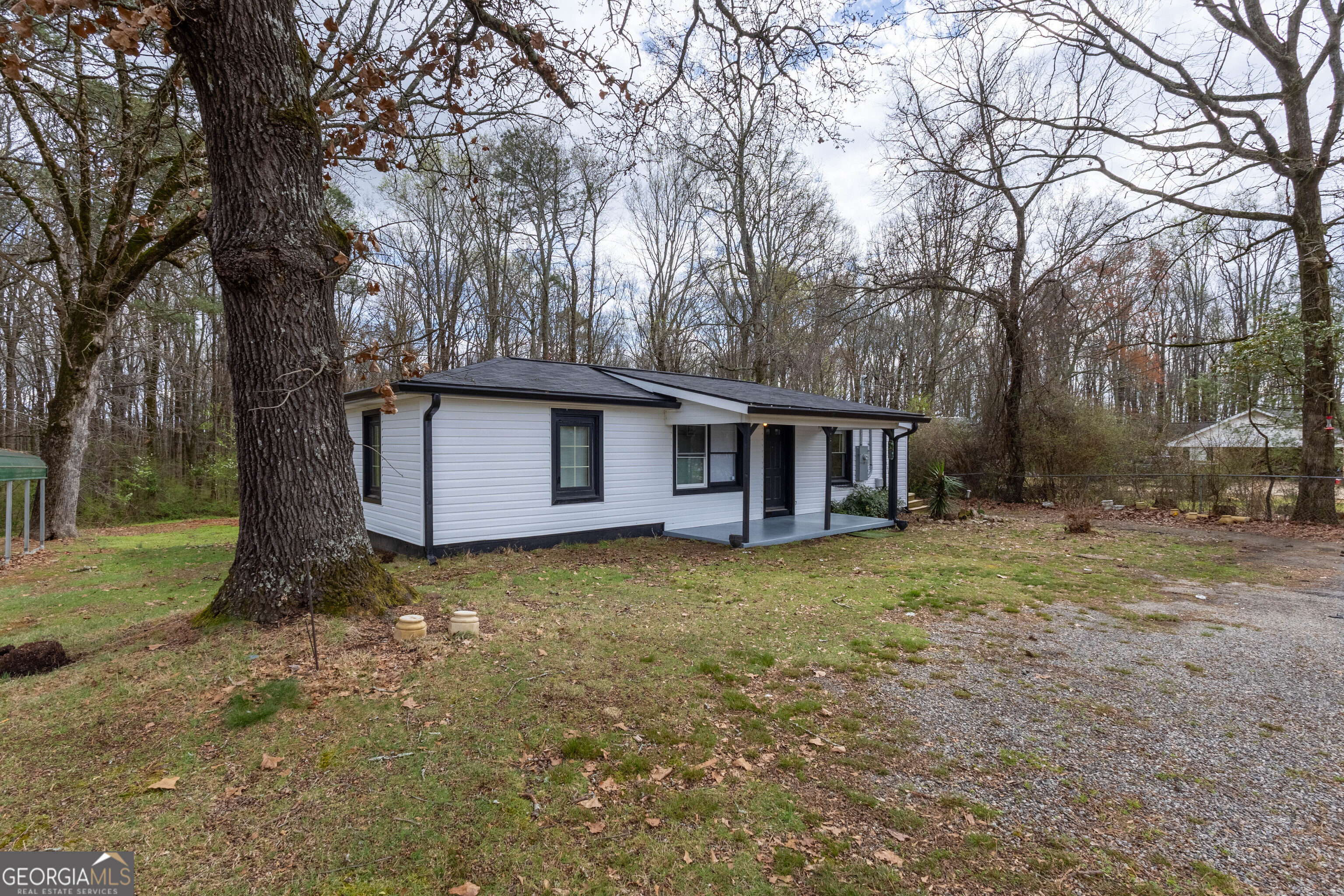 5326 Heardsville Road Cumming, GA 30028 - Photo 4 of 22 a view of a house with backyard and trees