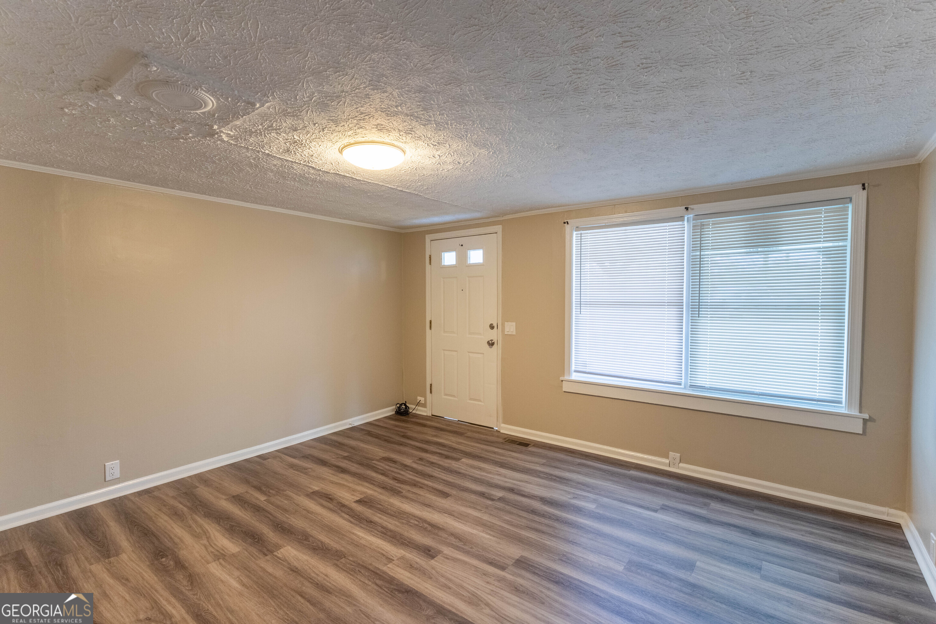 5326 Heardsville Road Cumming, GA 30028 - Photo 7 of 22 wooden floor in an empty room with a window