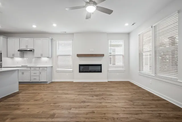 a view of kitchen with granite countertop stove top oven and cabinets