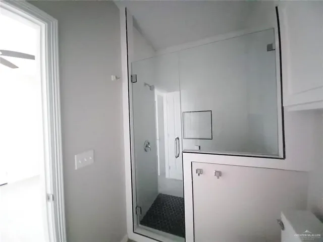 a bathroom with a shower and mirror