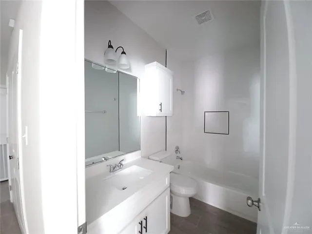 a bathroom with a double vanity sink mirror double and shower