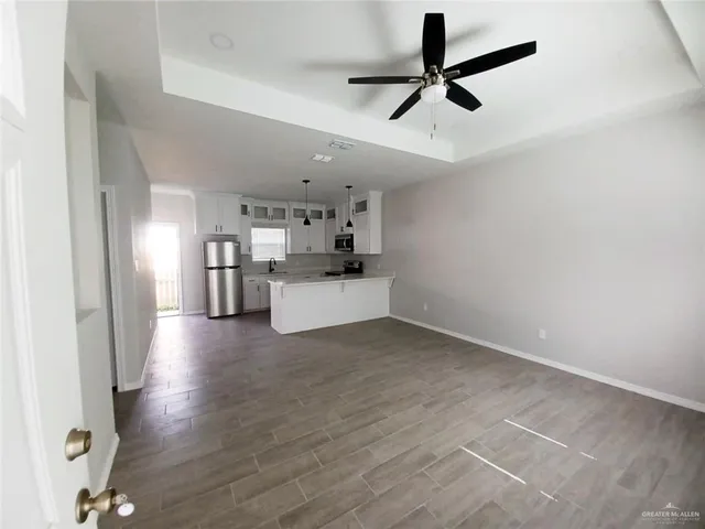 a view of a kitchen with a sink stainless steel appliances