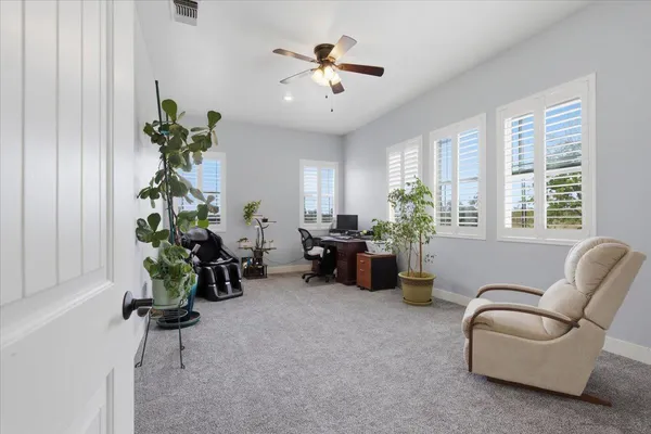 a kitchen with stainless steel appliances kitchen island granite countertop a refrigerator and cabinets