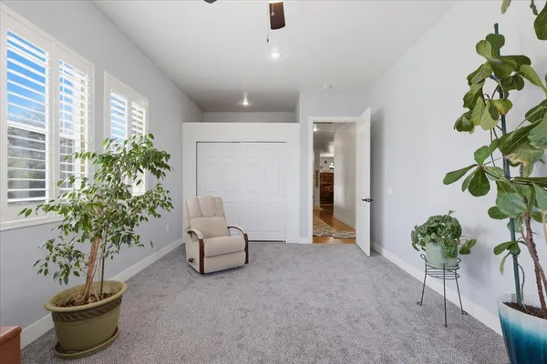 a kitchen with stainless steel appliances kitchen island granite countertop a table chairs and a refrigerator