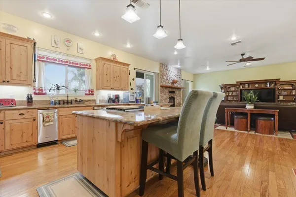 a kitchen with granite countertop a sink a washer and dryer
